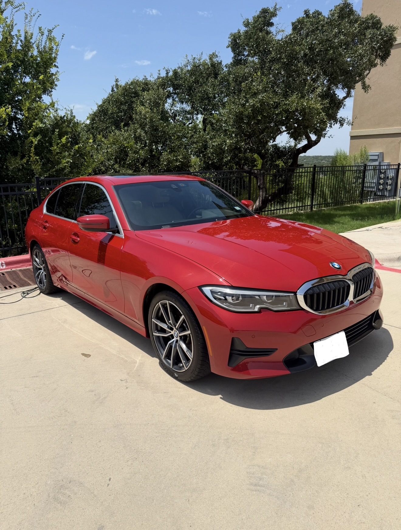 Red BMW sedan after a full mobile detail