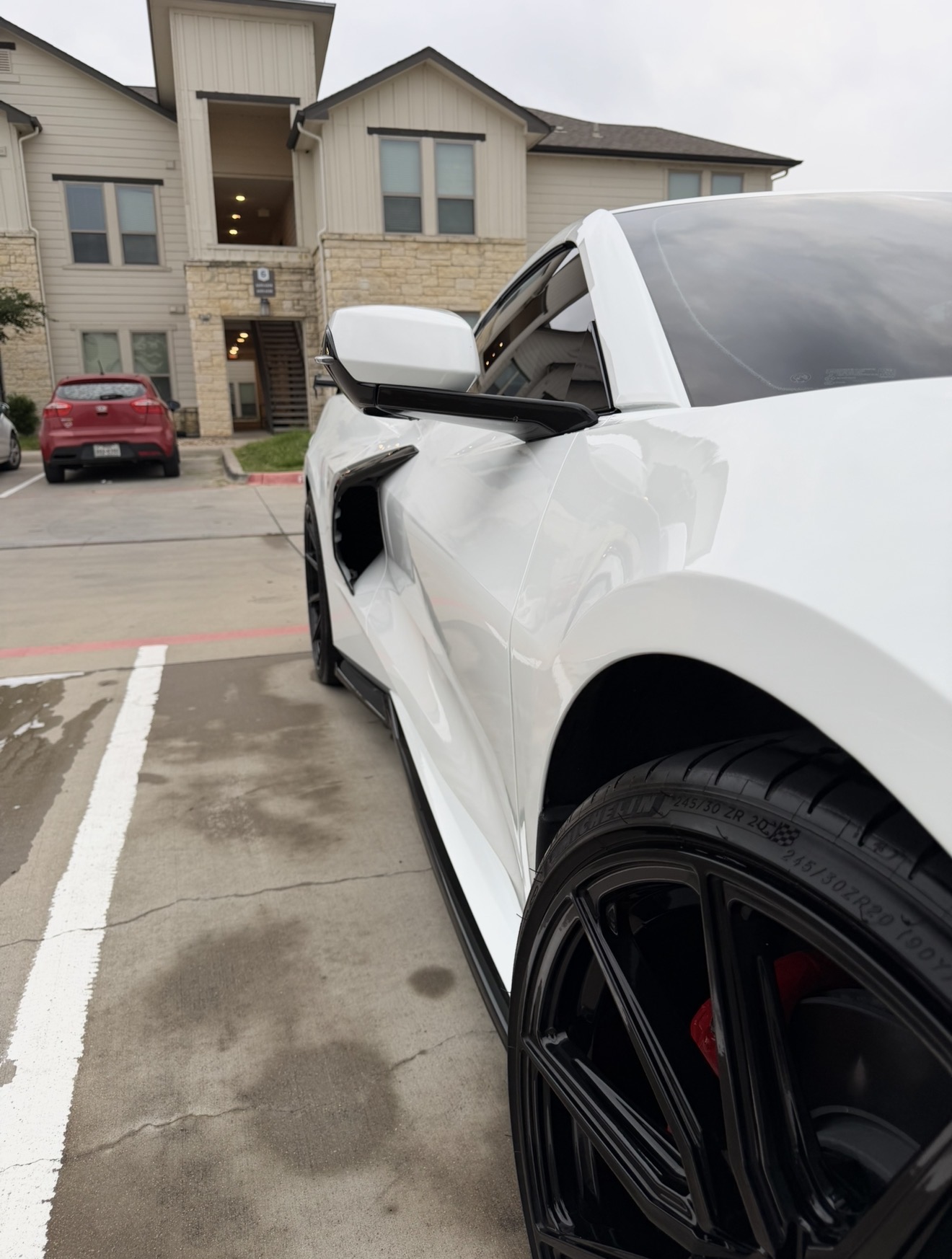 White Chevrolet Corvette with a glossy detailed finish