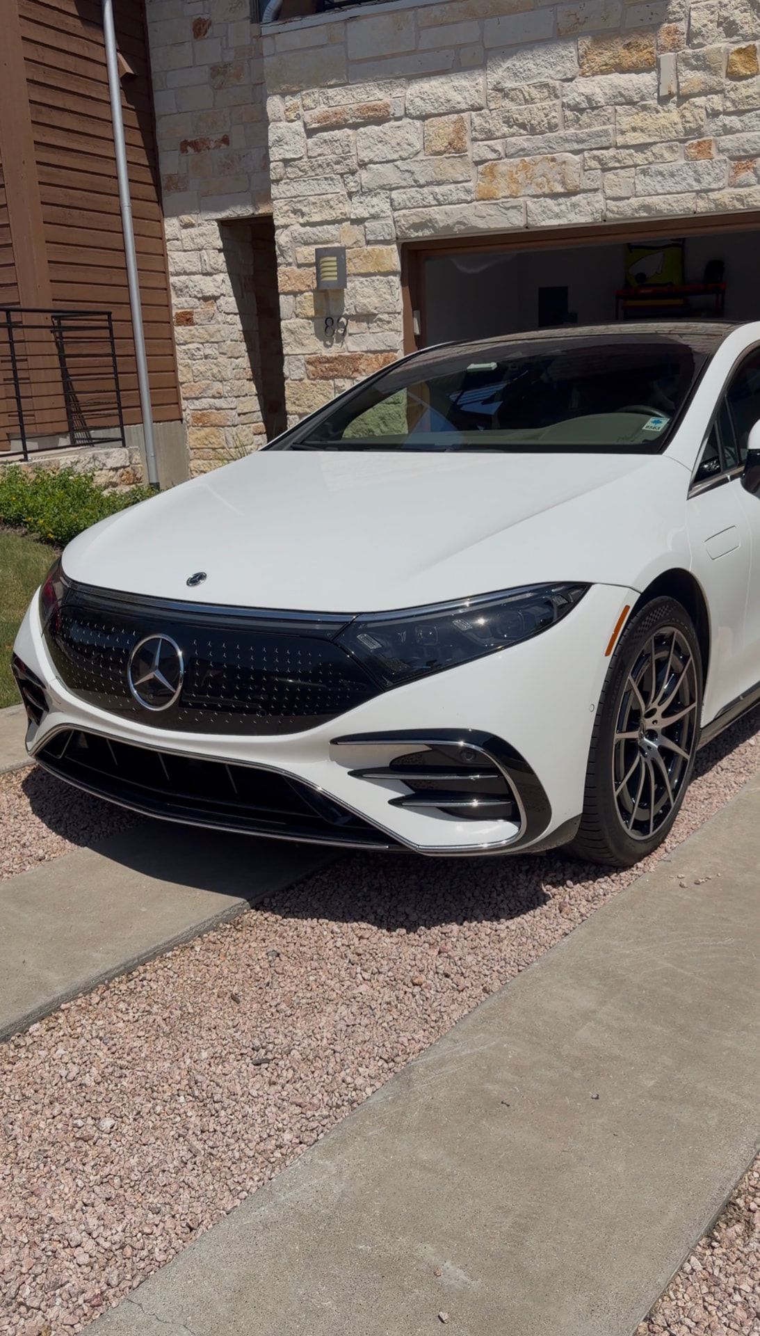 White Mercedes-Benz sedan freshly detailed in a driveway