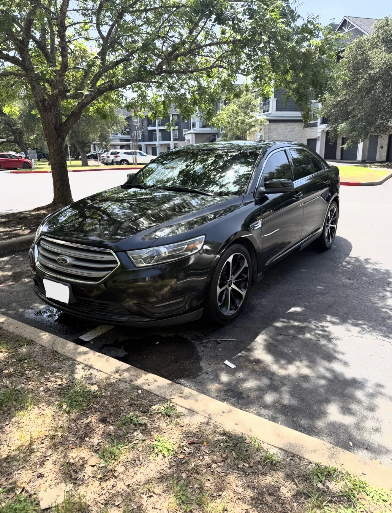Black Ford Taurus sedan after a full mobile detail
